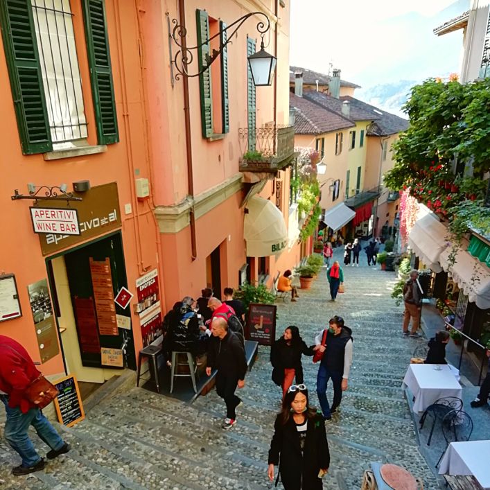 Steep street with restaurants in Bellagio, Lake Como, Italy