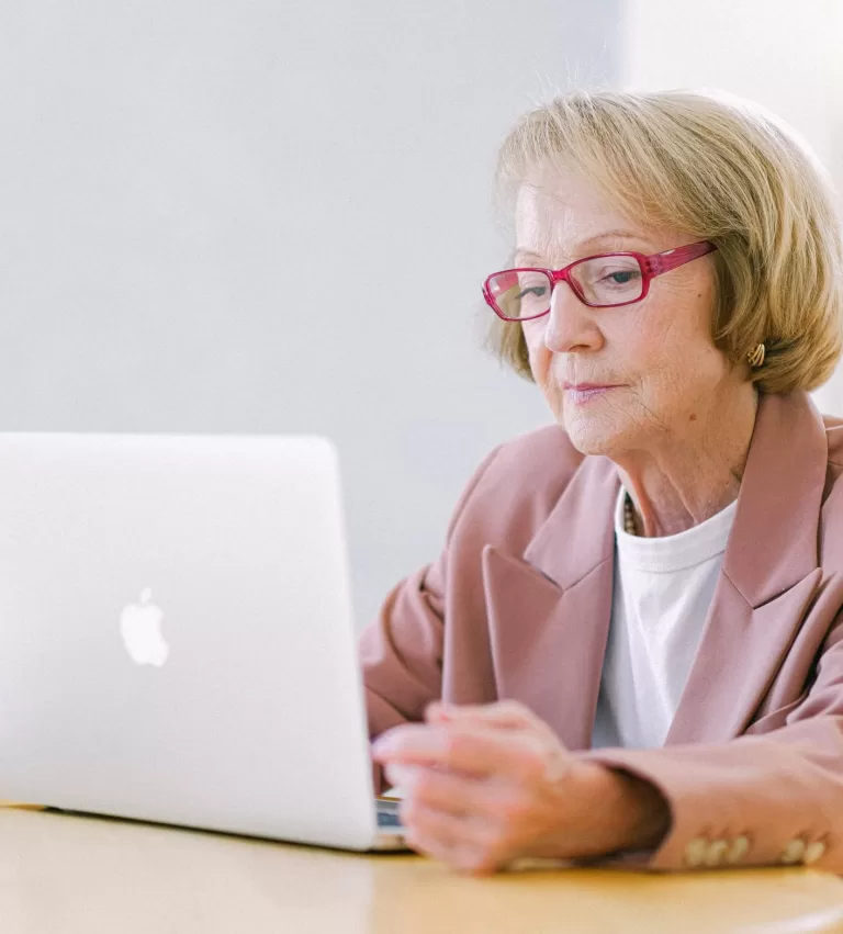 senior-lady-with-glasses-working-on-laptop