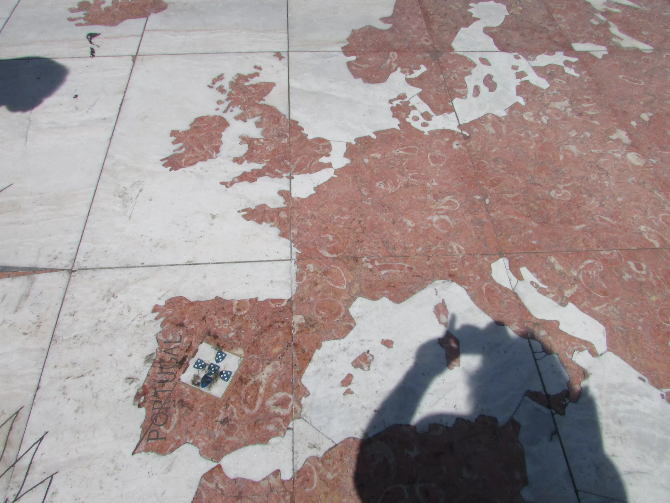 map of Europe on the pavement, shadow of photographer, Lisbon, portugal