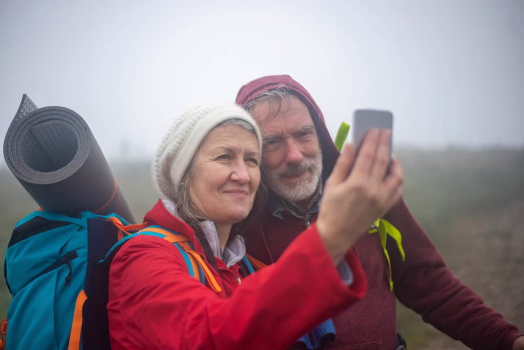 senior couple hiking and making selfie